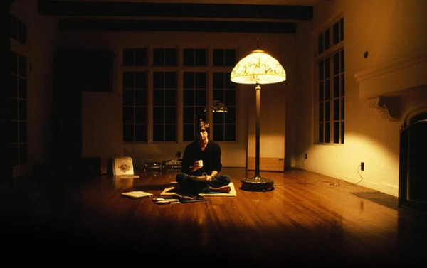 Apple Former CEO Steve Jobs sitting in his early day executive office